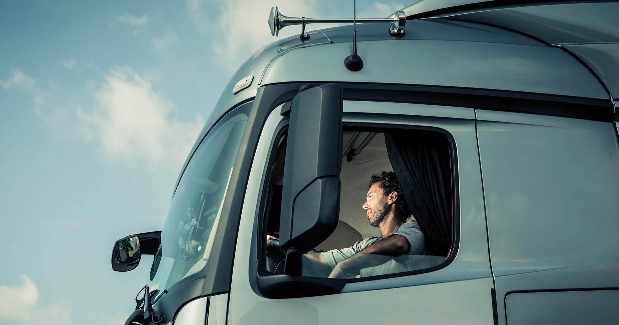 Portrait of a truck driver sitting in cab